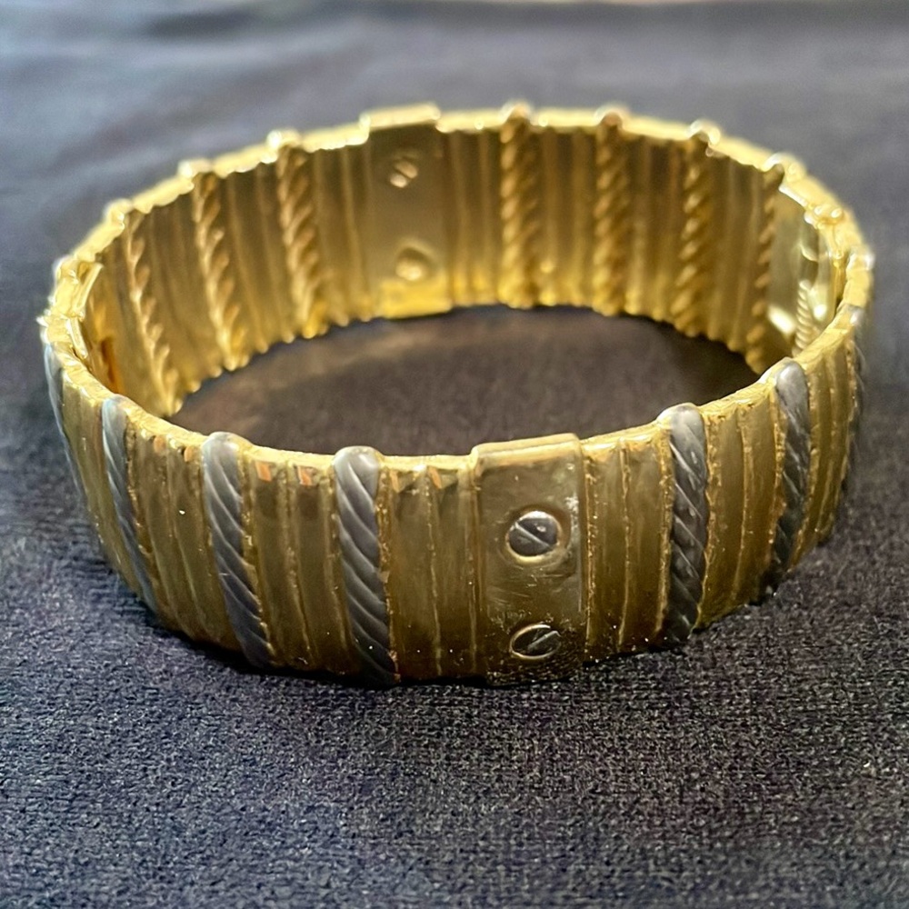 Goldtone bangle bracelet with hinge clasp to fit most any wrist. Excellent cond.